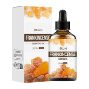Frankincense essential oil bottle with plant leaves