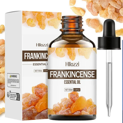 Frankincense essential oil bottle with plant leaves