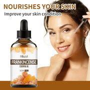 Frankincense essential oil bottle with plant leaves