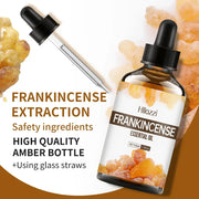 Frankincense essential oil bottle with plant leaves
