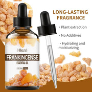 Frankincense essential oil bottle with plant leaves